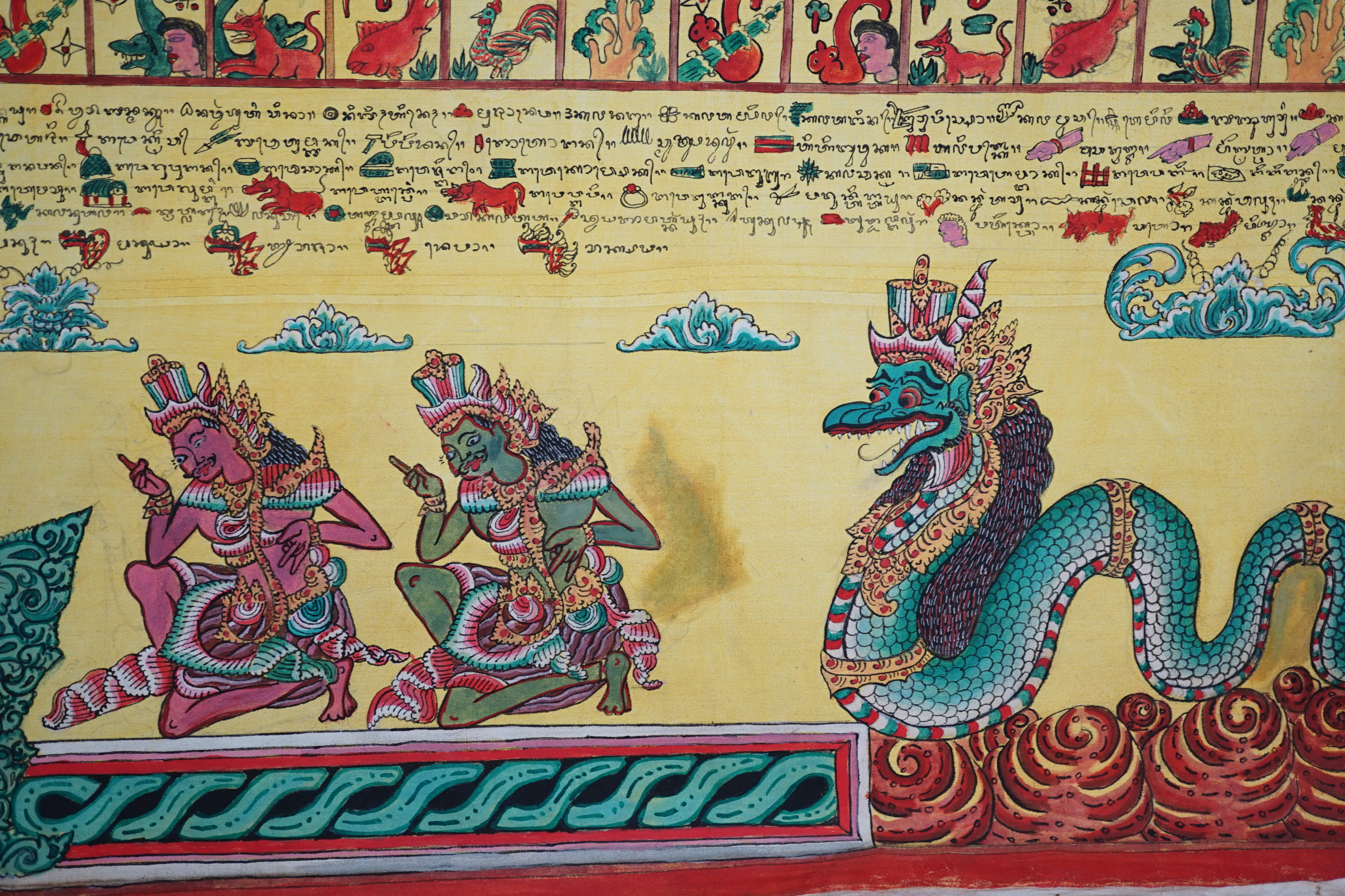 An Indonesian hand painted calendar and two similar figures, tallest 21cm